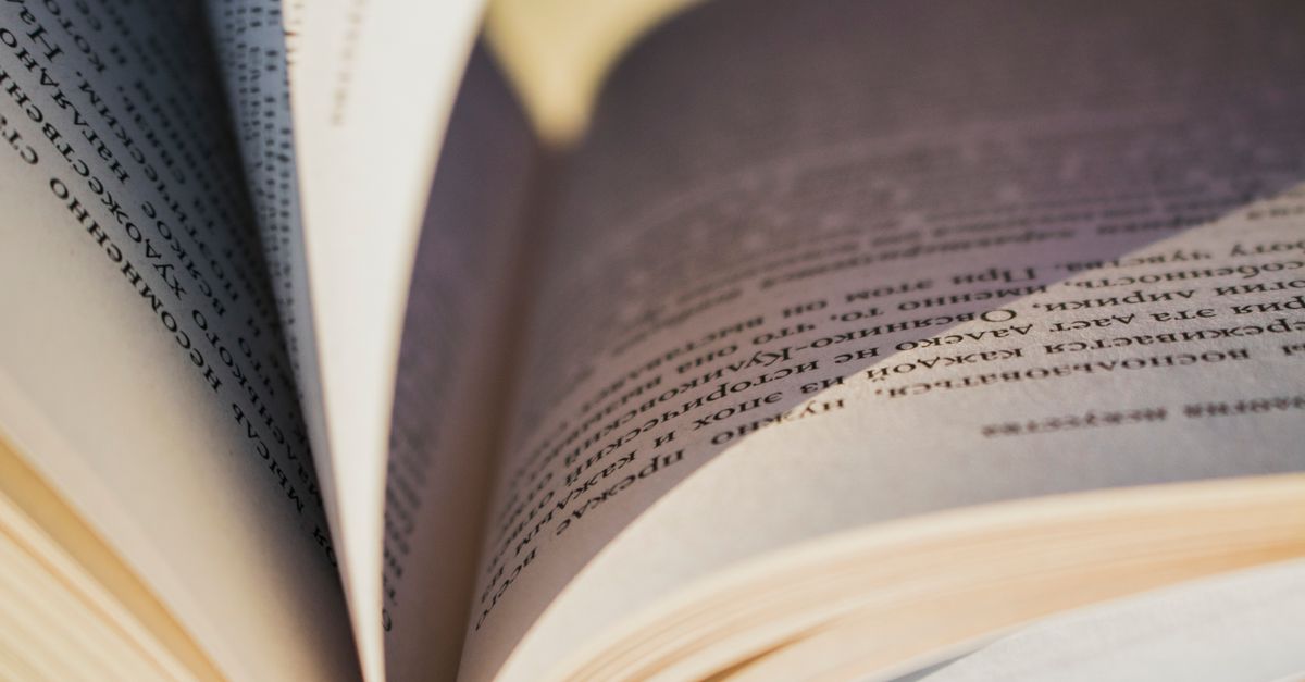 Detailed close-up image of an open book showing the textured pages and printed text.